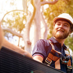 Solar installer smiling whilst working