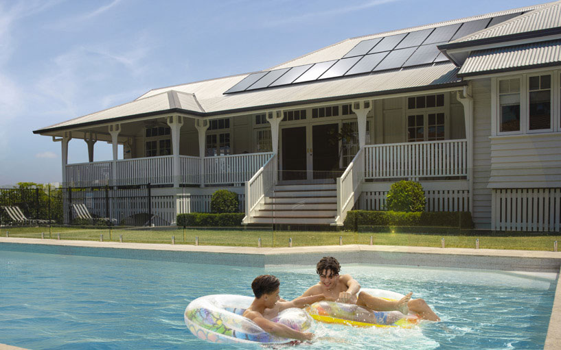 House with pool in foreground and Silhouette solar panels installed on its roof